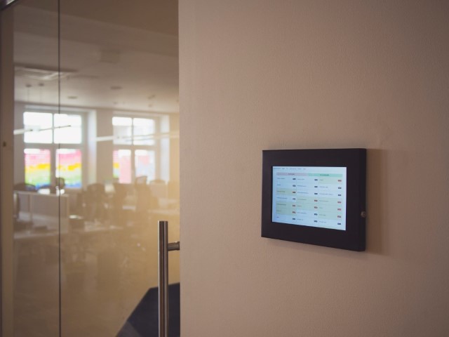 photo of a tablet on the wall near a conference room